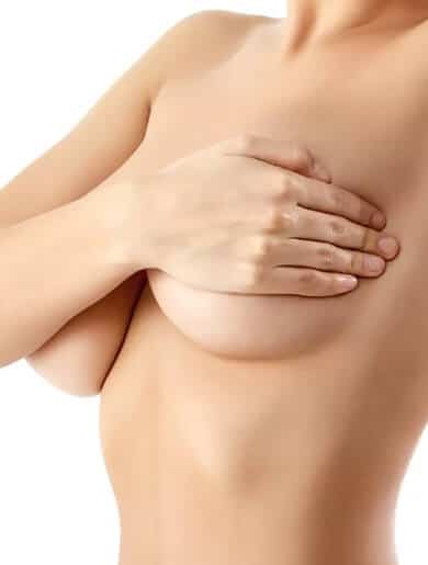 woman covering her breasts with her hand