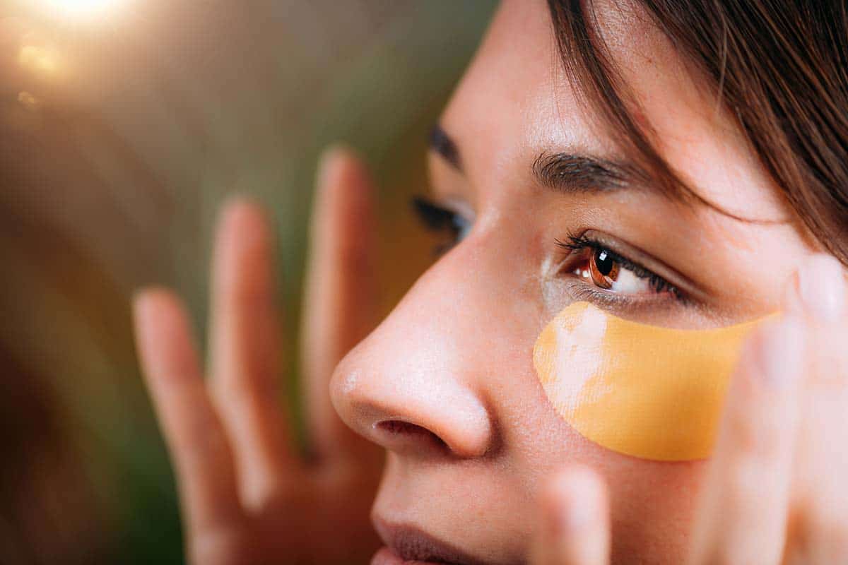 woman using beauty pads for at home eye bag treatment