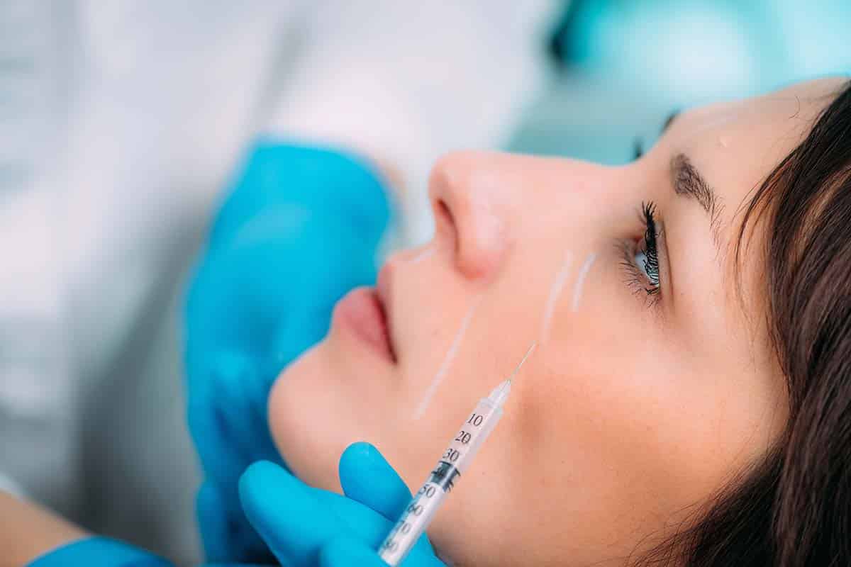 woman getting dermal filler injection for eye bags