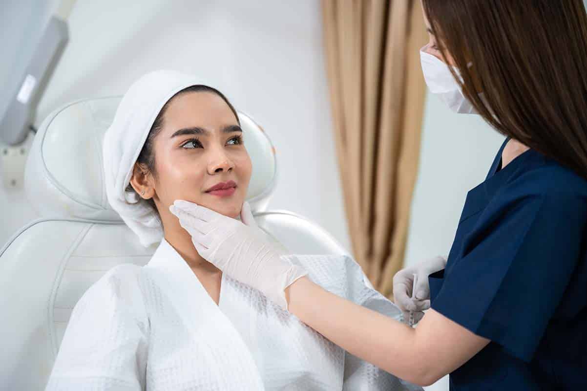young asian woman at skin care clinic for eye wrinkles and fine lines